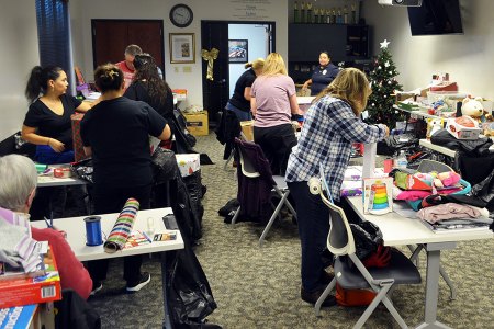 There were plenty of volunteers on hand Monday morning gift wrapping presents for the Lemoore Police Department's annual "Reasons for the Season" scheduled for Thursday in the Lemoore Civic Auditorium.